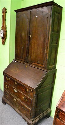 Lot 1386 - An 18th century oak bureau bookcase