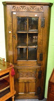 Lot 1390 - A reproduction oak standing corner cupboard