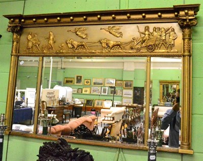 Lot 1397 - A Recency gilt gesso sectional inverted break front over mantel mirror