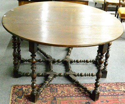 Lot 1410 - A 17th century and later oak gateleg table, with heavily turned legs and stretcher