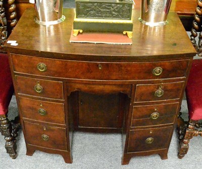 Lot 1417 - A George III mahogany bow fronted kneehole desk