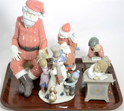 Lot 3 - A Lladro model of a snowman; another of Father Christmas; two Nao models of Father Christmas;...