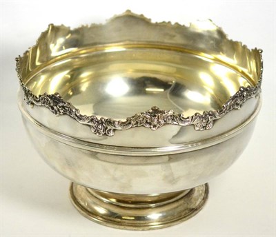 Lot 7 - A large silver punch bowl, with shaped foliate rim on circular foot