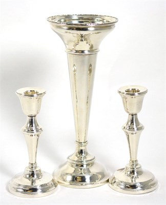 Lot 13 - A large silver trumpet shaped vase; and a pair of silver candlesticks