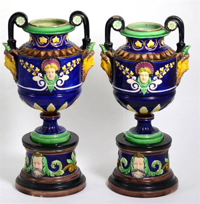 Lot 34 - A pair of majolica Minton style pedestal vases decorated with masks, 35cm high