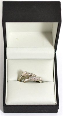 Lot 69 - A 9 carat white gold diamond solitaire ring, with diamond set shoulders, total stated diamond...