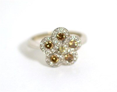 Lot 72 - An 18 carat white gold champagne and white diamond cluster ring, total estimated diamond weight...