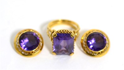 Lot 89 - A synthetic colour change sapphire ring and pair of earrings (2)