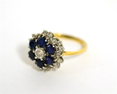 Lot 93 - A sapphire and diamond cluster ring, total estimated diamond weight 0.45 carat approximately,...