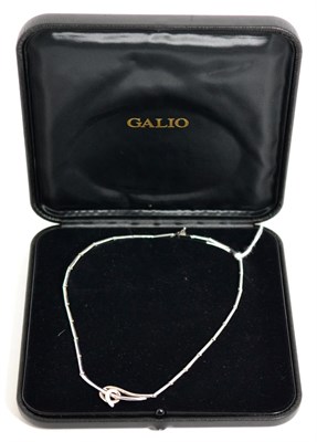 Lot 100 - An 18 carat white gold diamond set necklace, total estimated diamond weight 0.10 carat...