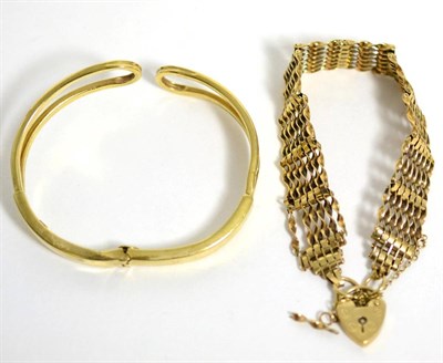 Lot 102 - A 9 carat gold gate link bracelet (a.f.) and a hinged bangle stamped '375' (2)