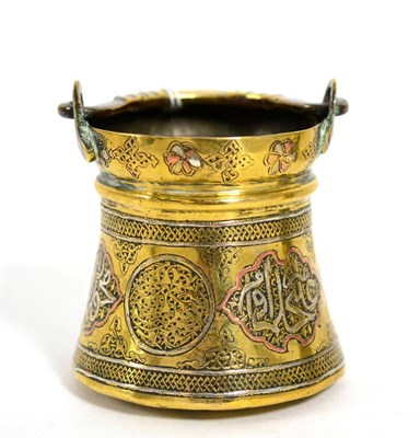 Lot 139 - A miniature Persian brass cauldron with shaped handled in the 16th century style