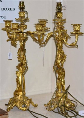 Lot 208 - A pair of gilt bronze four-light candelabra, late 19th century, with foliate sconces and...