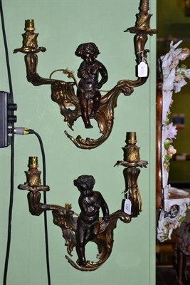 Lot 221 - A pair of gilt and patinated twin-light wall lights, late 19th century, with foliate sconces...