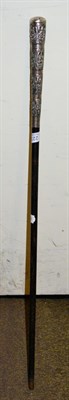 Lot 223 - An Indian white metal mounted walking cane, the handled decorated with four bands of figures in...