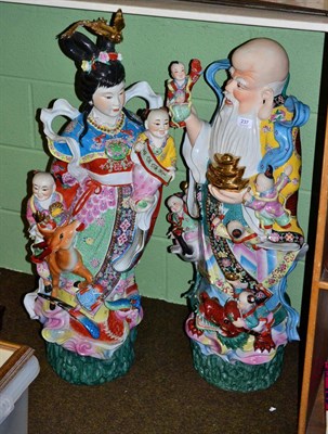 Lot 237 - A pair of large Chinese figures of Guanyin and an Immortal, in bright overglaze palette,...