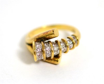 Lot 301 - An 18 carat gold diamond set cross over ring, total estimated diamond weight 0.25 carat...