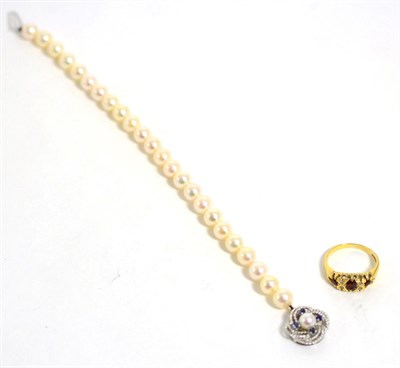 Lot 306 - An 18 carat gold garnet and diamond ring and a cultured pearl bracelet with sapphire clasp