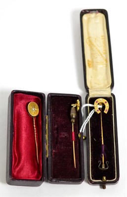 Lot 307 - A diamond and ruby stick pin, a ruby stick pin and a seed pearl stick pin