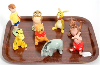 Lot 352 - A set of seven Beswick Walt Disney Winnie the Pooh figures, together with a Wade Eeyore figure