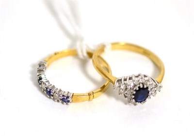 Lot 386 - A 9 carat gold sapphire and diamond cluster ring, total estimated diamond weight 0.20 carat...