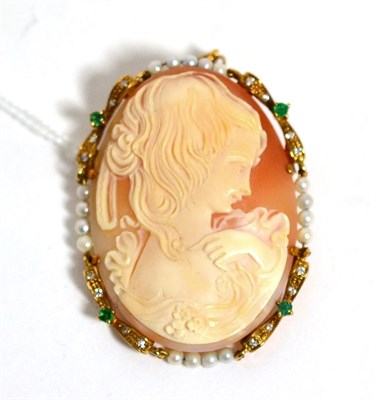 Lot 395 - A carved shell cameo depicting a female bust, within a pearl, emerald and diamond set frame,...