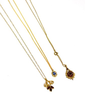 Lot 397 - Two 9 carat gold garnet pendants on chains and another pendant on chain (3)