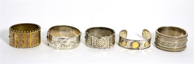 Lot 403 - A Victorian silver hinge opening bangle with engraved and beaded detail, two other Victorian...