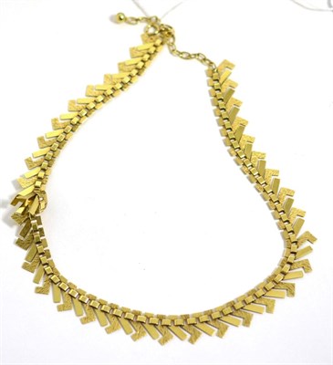 Lot 436 - A fancy textured link fringe necklace, stamped '585'