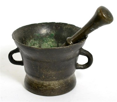 Lot 450 - A 17th century bronze mortar, of flared form with twin loop handles, 11cm high; and a similar...