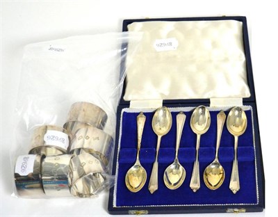 Lot 482 - Eight silver napkin rings and set of six spoons, cased (qty)