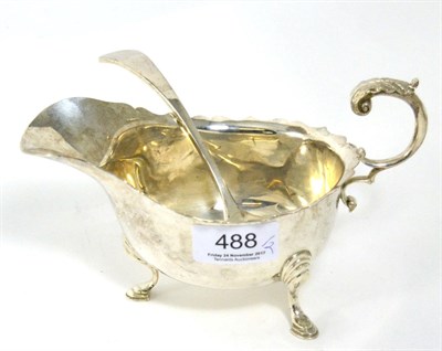 Lot 488 - A Georgian style silver sauceboat and sauce ladle (2)