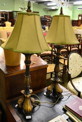 Lot 525 - A pair of 20th century black and gold painted table lamps, with green silk shades