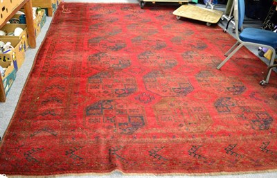 Lot 1108 - Turkmen carpet, North Afghanistan, the claret field with three columns of elephant foot guls...