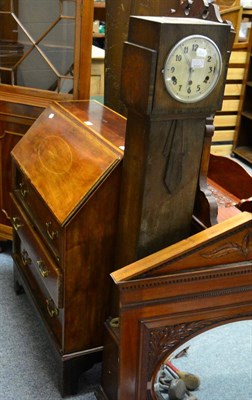 Lot 1131 - A 1920's oak small longcase clock and a reproduction bureau