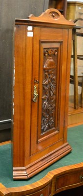 Lot 1134 - A late Victorian carved walnut corner cabinet