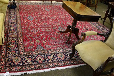 Lot 1238 - Tabriz carpet, Iranian Azerbaijan, the crimson field of scrolling vines enclosed by palmette...