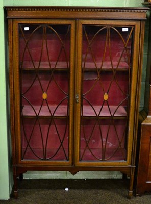 Lot 1259 - An Edwardian cross banded and string inlaid display cabinet