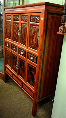 Lot 1268 - A 20th century part ebonised Chinese softwood cabinet fitted with an arrangement of cupboard...