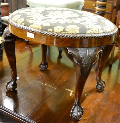 Lot 1290 - A mahogany oval stool on ball & claw feet