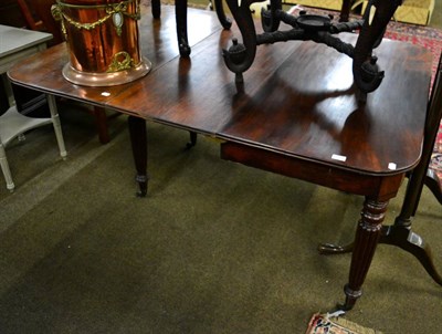 Lot 1294 - A 19th century mahogany small extending dining table with single leaf on fluted supports