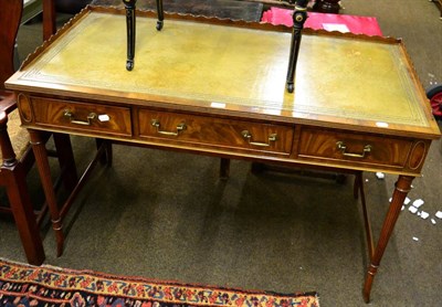 Lot 1301 - Reproduction writing table with inset leather top, shaped gallery fitted with three drawers and...