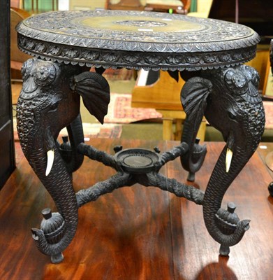 Lot 1307 - A 19th century Anglo Indian carved occasional table with elephant mask legs and snake carved...