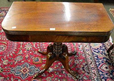 Lot 1308 - A 19th century mahogany fold-over tea table on a turned column and four swept supports