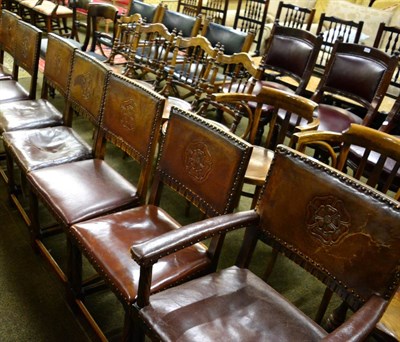 Lot 1321 - A set of eight 1920's oak framed studded and tooled leather dining chairs inlcuding two carvers