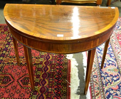 Lot 1340 - An early 19th century mahogany and satinwood crossbanded demi lune tea table, tapered square legs