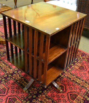 Lot 1341 - Mahogany revolving bookcase on reeded swept supports