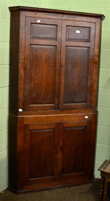 Lot 1377 - A 19th century oak free standing corner cupboard with shelved interior