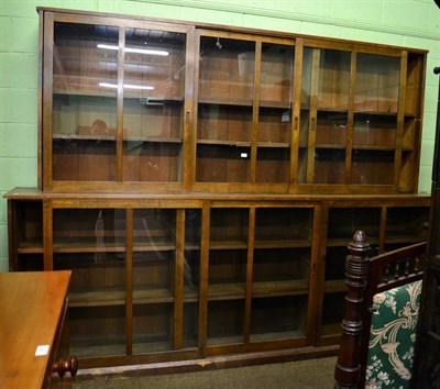 Lot 1378 - Large oak bookcase with sliding doors