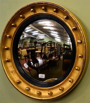 Lot 1380 - A Regency style giltwood convex wall mirror